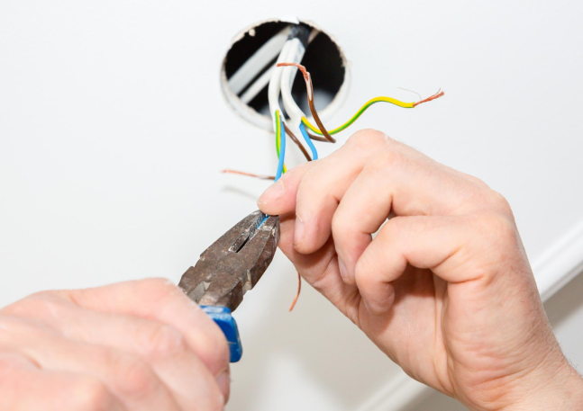 man-is-holding-pliers-his-hands-electrical-insulator-light-bulb-adhesive-tape-maintenance-repair-works-flat-restoration-indoors 1